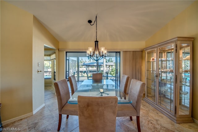 tiled dining area with a chandelier