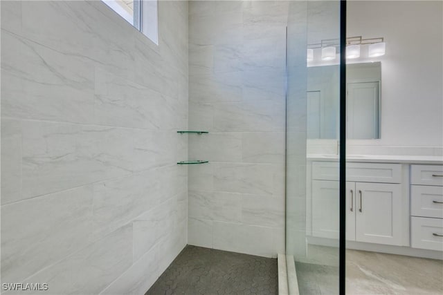 bathroom featuring vanity and tiled shower