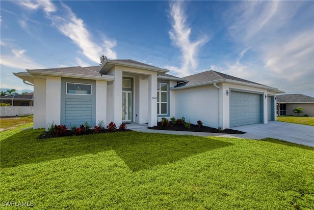 view of front of home with a garage and a front lawn