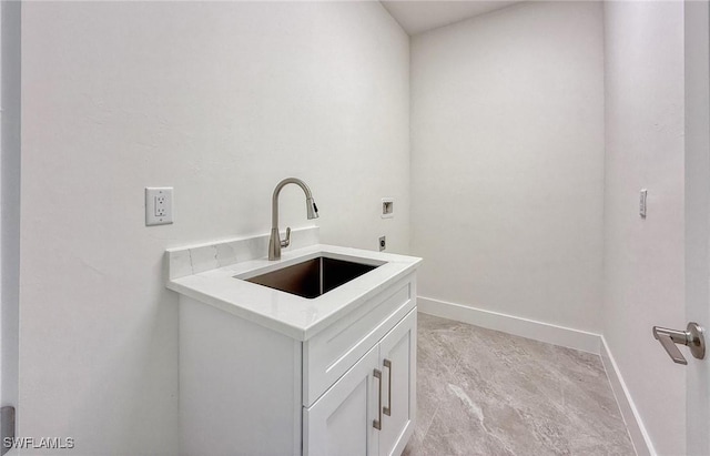 laundry room with cabinets, washer hookup, and sink