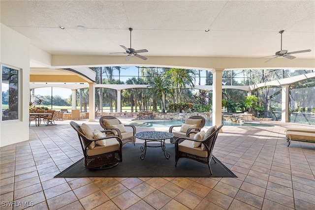 view of patio featuring an outdoor living space, ceiling fan, and a lanai