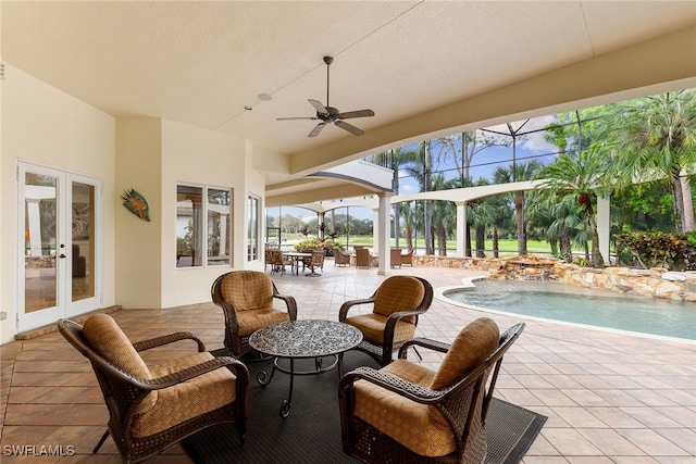 view of patio featuring french doors, pool water feature, glass enclosure, and ceiling fan