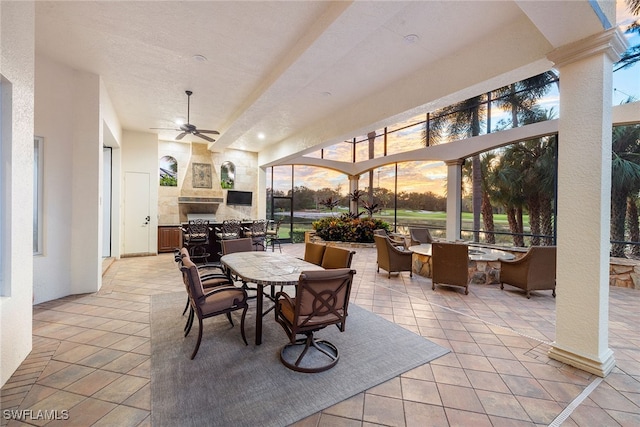 exterior space with a stone fireplace and ceiling fan