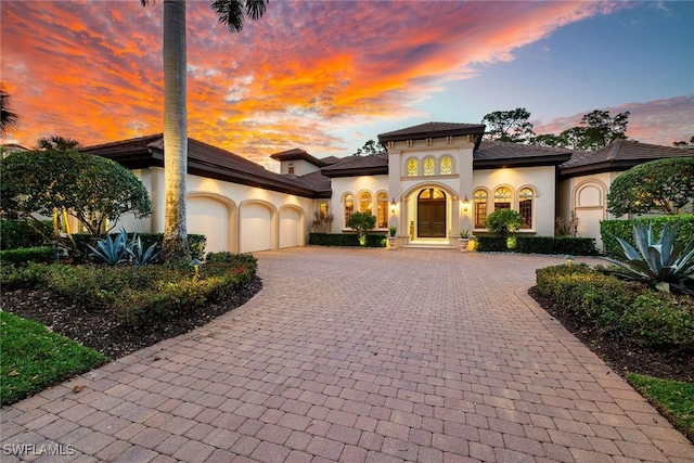 mediterranean / spanish house with a garage