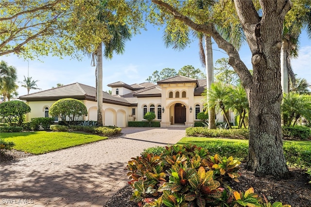 mediterranean / spanish home featuring a front yard