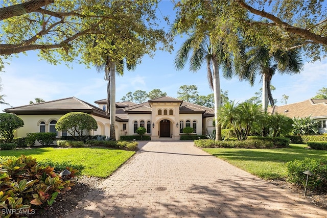 mediterranean / spanish house with a front lawn