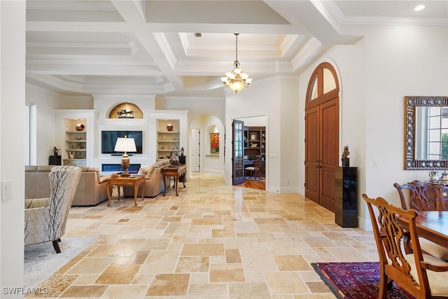 foyer entrance with a notable chandelier and crown molding