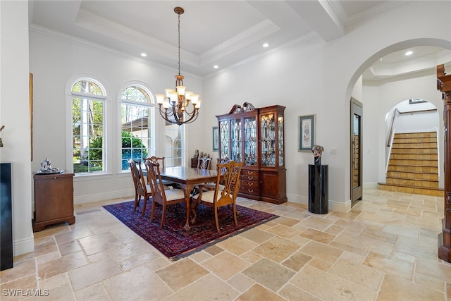 dining space featuring a high ceiling, an inviting chandelier, and crown molding