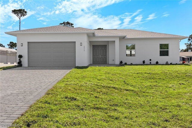 view of front of property with a front yard and a garage