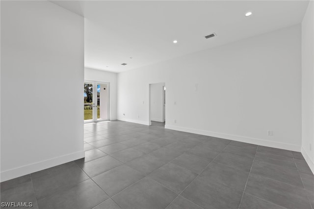 tiled spare room with french doors