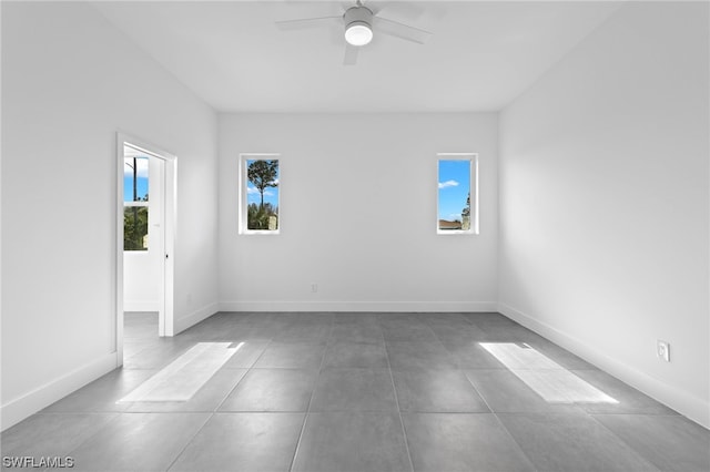 tiled empty room with ceiling fan