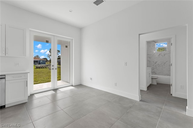 interior space featuring a wealth of natural light, light tile patterned floors, and french doors