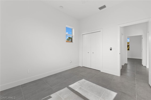 unfurnished bedroom featuring a closet and tile patterned floors