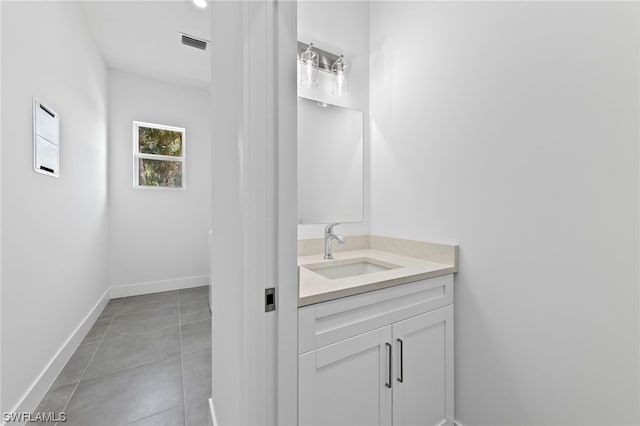 bathroom featuring tile patterned flooring and vanity