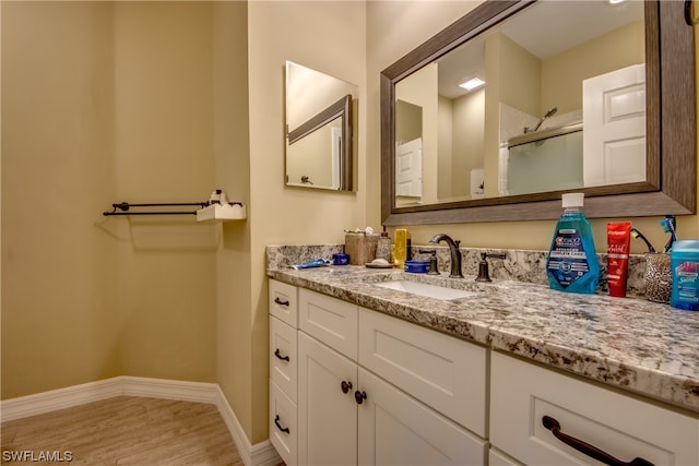 bathroom featuring wood-type flooring and vanity