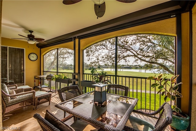 sunroom featuring ceiling fan