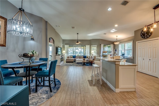 kitchen featuring decorative light fixtures, a wealth of natural light, and light wood-type flooring