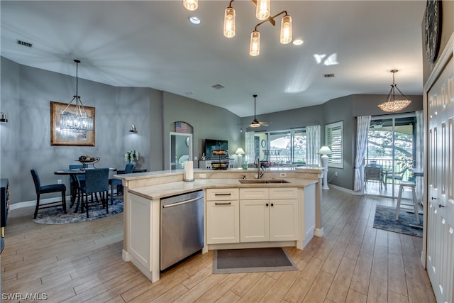 kitchen featuring sink, hanging light fixtures, stainless steel dishwasher, ceiling fan with notable chandelier, and white cabinetry