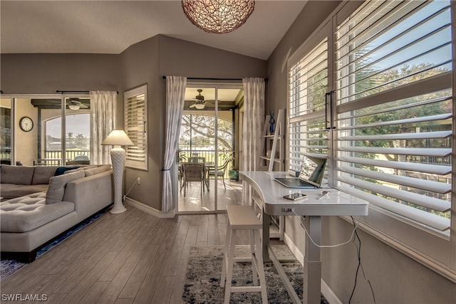 home office featuring vaulted ceiling and dark hardwood / wood-style flooring