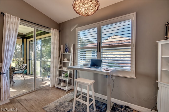 office space featuring lofted ceiling and light hardwood / wood-style floors