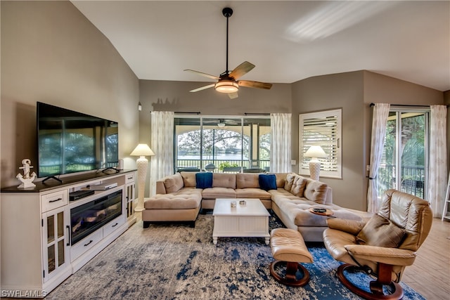 living room featuring vaulted ceiling, hardwood / wood-style floors, ceiling fan, and a wealth of natural light