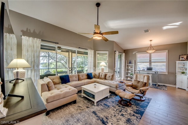 living room featuring lofted ceiling, ceiling fan, and hardwood / wood-style flooring