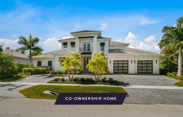 mediterranean / spanish house featuring a garage and a balcony