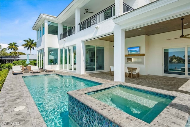 view of swimming pool with ceiling fan, an outdoor living space, an in ground hot tub, and a patio area