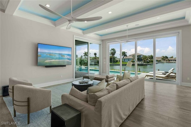 living room with plenty of natural light, crown molding, and light hardwood / wood-style flooring