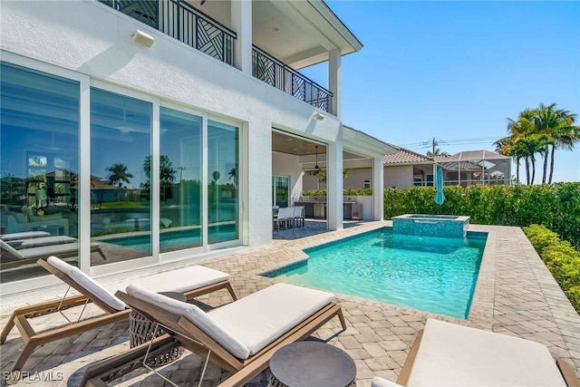 view of swimming pool featuring an in ground hot tub and a patio