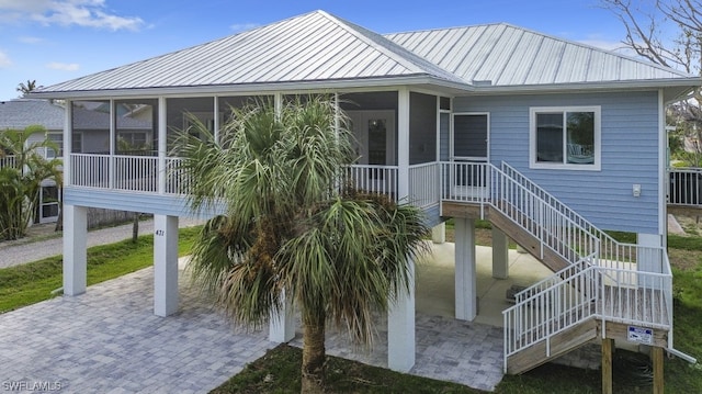 back of property with a sunroom