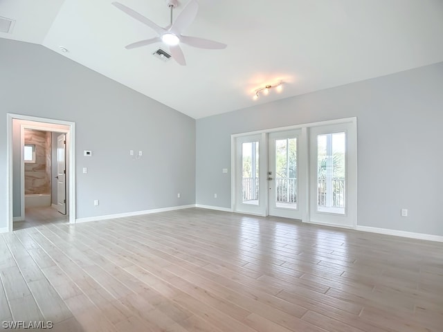 unfurnished room featuring ceiling fan, vaulted ceiling, and light wood-type flooring