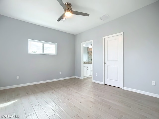 empty room featuring ceiling fan and light wood-type flooring