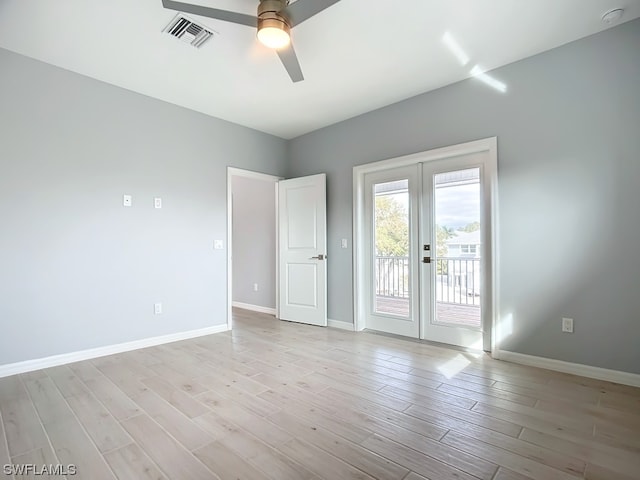 unfurnished room featuring ceiling fan, french doors, and light wood-type flooring