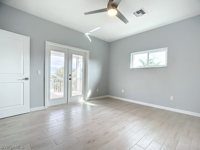 unfurnished room with light wood-type flooring, ceiling fan, and french doors