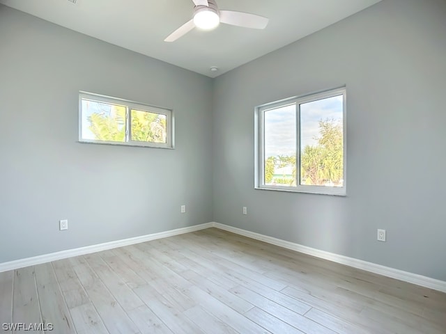 spare room featuring plenty of natural light, light hardwood / wood-style floors, and ceiling fan