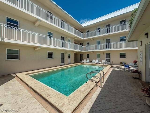 view of swimming pool with a patio