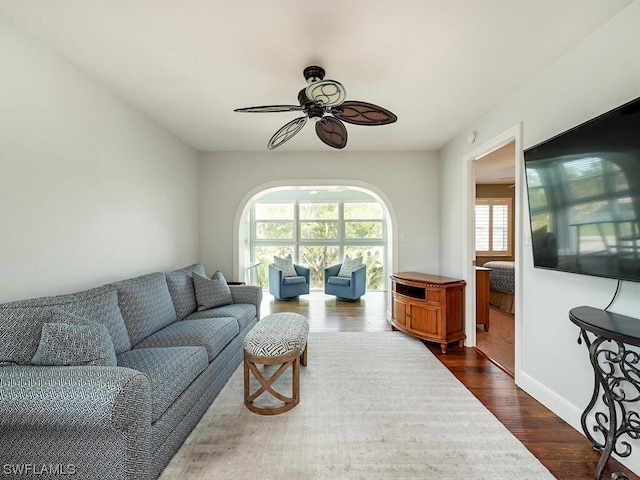 living room featuring dark hardwood / wood-style floors and ceiling fan