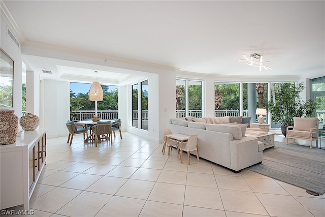 tiled living room with crown molding and a tray ceiling