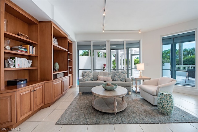 sitting room with rail lighting, french doors, and a wealth of natural light