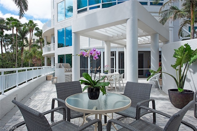 view of patio featuring a balcony and grilling area