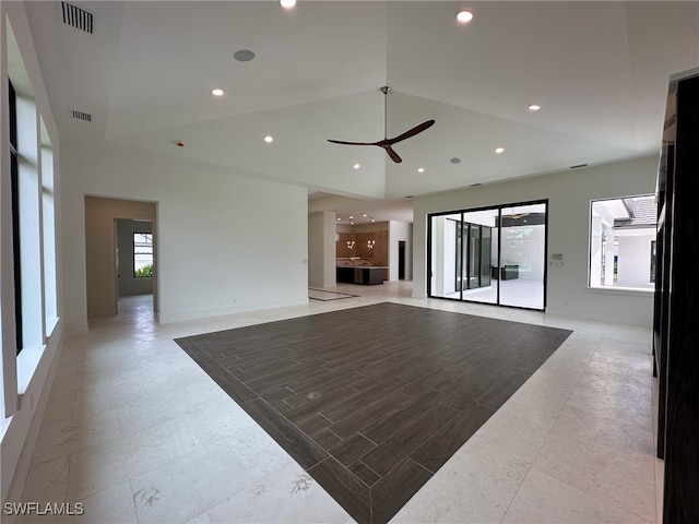 tiled living room featuring a high ceiling and ceiling fan