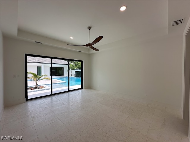 tiled empty room featuring ceiling fan