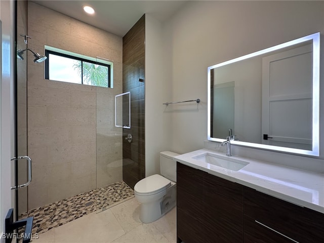 bathroom featuring vanity, toilet, tile patterned floors, and walk in shower