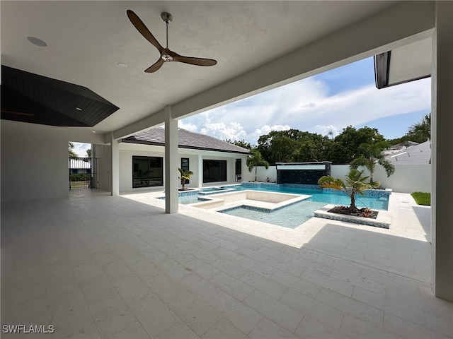 view of pool with ceiling fan, a patio area, and an in ground hot tub