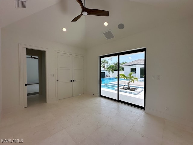 unfurnished bedroom featuring ceiling fan, light tile patterned flooring, vaulted ceiling, and access to outside