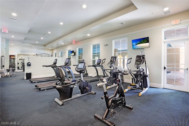 gym featuring a tray ceiling