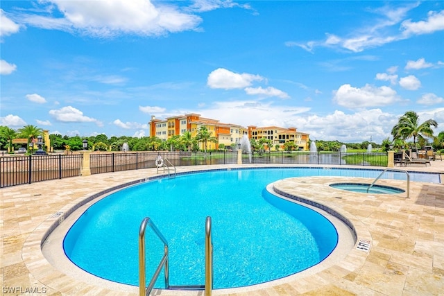 view of swimming pool with a community hot tub and a patio area