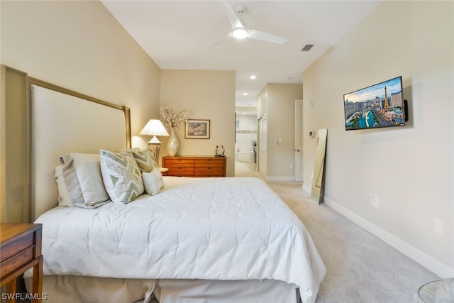 carpeted bedroom with ceiling fan and connected bathroom