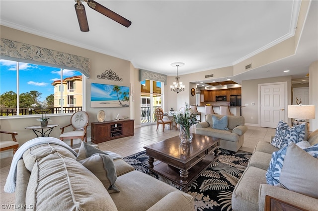 tiled living room with ceiling fan with notable chandelier and ornamental molding